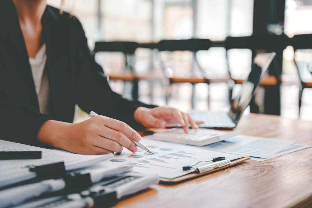 business woman or accountant who are using a calculator to calculate business data Accounting docume