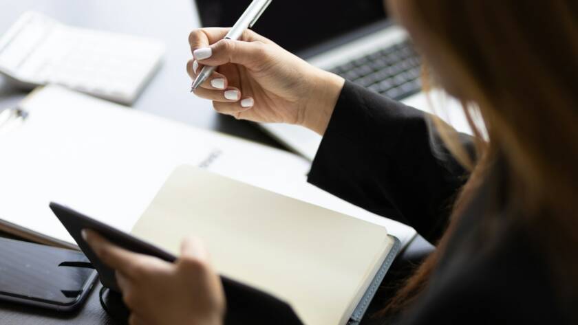 Business woman working in an office writes financial and accounting records.
